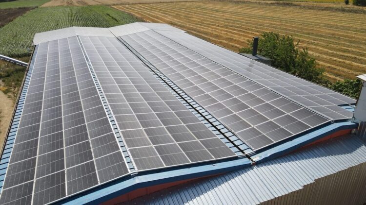 Aerial view of rooftop solar panels on a farm building